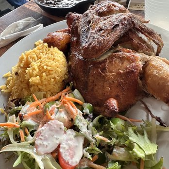 Sofrito Latin Cafe - Pollo horneado with yellow rice black beans and plantains. Salad comes with plate. - Latin American Near Me - Orlando, Florida Sofrito Latin Cafe - Pollo horneado with yellow rice black beans and plantains. Salad comes with plate. - Latin American Near Me - Orlando, Florida