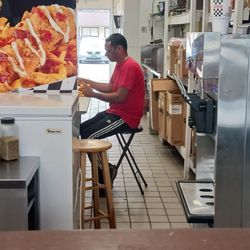 Rally's - Employee handling cheese slices with no gloves. He walked in from the open back door, didn't wash his hands.
