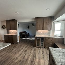 Rustic alder cabinets, granite countertops, tile backsplash, laminate floors