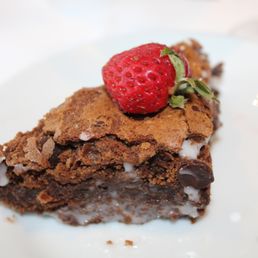 a piece of chocolate cake with a strawberry on top a piece of chocolate cake with a strawberry on top