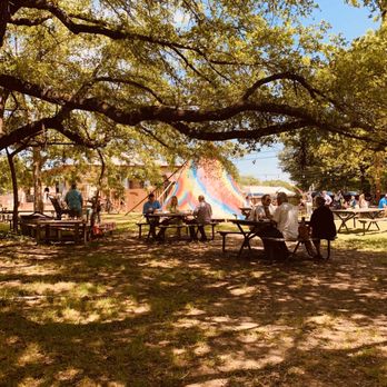 The Forge - a group of people sitting at picnic tables under a large tree - American Near Me - Ben Wheeler, Texas The Forge - a group of people sitting at picnic tables under a large tree - American Near Me - Ben Wheeler, Texas