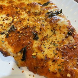 a slice of pizza on a paper plate