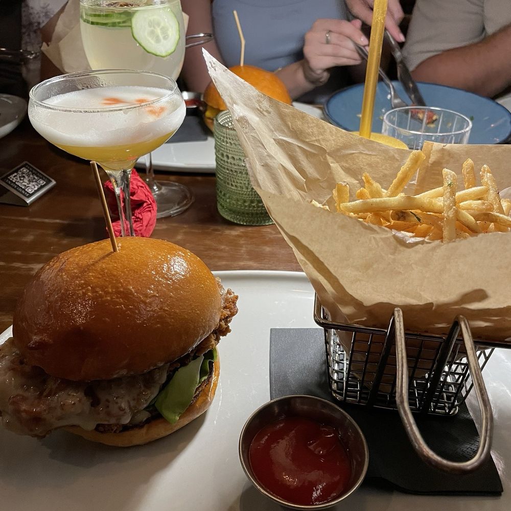 Le Chick - Fried Chicken Bun Burger with regular fries - Cocktail Bars Near Me - Miami, Florida Le Chick - Fried Chicken Bun Burger with regular fries - Cocktail Bars Near Me - Miami, Florida