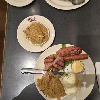 Veselka - Beef Stroganoff (top) and Mixed Ukrainian Grill (bottom) with side of Sauerkraut and Burachky (red) - Ukrainian Near Me - New York, New York