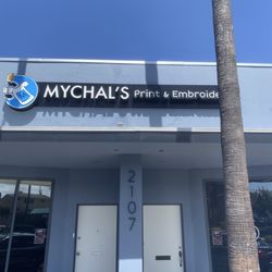Mychal's Printing & Embroidery - Storefront. NEW Location as of Aug 2026