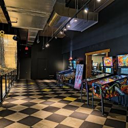 ENTERRIUM - Entrance to separate room for pinball machines is between these four pinball machines next to the bowling alley.