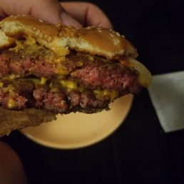 a hand holding a hamburger a hand holding a hamburger