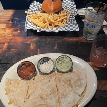 The Standard Tavern - Quesadilla, Tito's on the beach in front, Tim Collin's drink and VGK burger in the back - American Near Me - Las Vegas, Nevada The Standard Tavern - Quesadilla, Tito's on the beach in front, Tim Collin's drink and VGK burger in the back - American Near Me - Las Vegas, Nevada