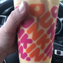  a person holding a drink in their hand