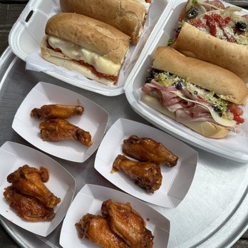 Martino's Pizzaria - a tray of hot dogs and wings - Pizza Near Me - Oakville, Connecticut Martino's Pizzaria - a tray of hot dogs and wings - Pizza Near Me - Oakville, Connecticut