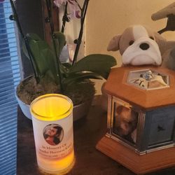 Newcomer Cremations, Funerals & Receptions - My son, Tim's urn, orchid and a candle, from Newcomer with the photo and information from his prayer card.