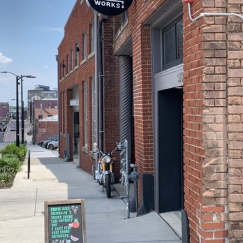 Knox Whiskey Works - a brick building with a sign on the sidewalk - Distilleries Near Me - Knoxville, Tennessee