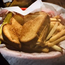 Grilled cheese sandwich with fries and a pickle spear