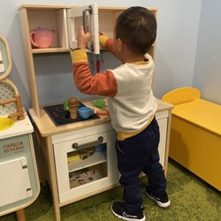 Tiffany H Ham, DDS MS - Playing with the play kitchen in the waiting room