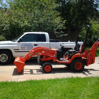 Porter Plumbing - a white truck and a tractor - Plumbing Near Me - College Station, Texas Porter Plumbing - a white truck and a tractor - Plumbing Near Me - College Station, Texas