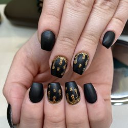 Ivy's Nails Salon - Hard gel- Matte black with gold glitter drips! Done by Anna C.