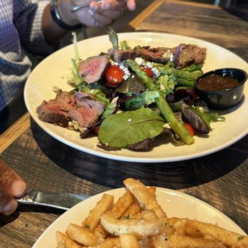 On The Kirb - Steak medium rare salad and Parmesan fries. Tasty - Gastropubs Near Me - Katy, Texas