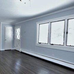 ARG Handyman Services - Updating a 70's home, here is the living room with beautifully refinished floor, painted walls and trim.