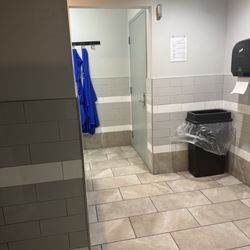 Janitor closet in main view of urinals