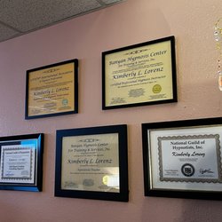 Lynne Coaching & Hypnosis - Certifications & Credentials Wall: Professional certifications and hypnosis credentials displayed inside Lynne Coaching & Hy...