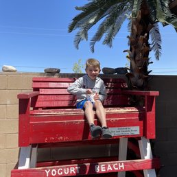 a young boy sitting on a bench a young boy sitting on a bench