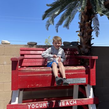 Yogurt Beach - Fernley - a young boy sitting on a bench - Ice Cream & Frozen Yogurt Near Me - Fernley, Nevada Yogurt Beach - Fernley - a young boy sitting on a bench - Ice Cream & Frozen Yogurt Near Me - Fernley, Nevada
