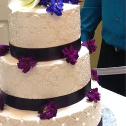 My cousins tried to decorate the cake with flowers since the cake guy neglected to do so! Cake is lopsided a little too! My cousins tried to decorate the cake with flowers since the cake guy neglected to do so! Cake is lopsided a little too!