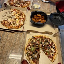 people eating pizza at a table people eating pizza at a table