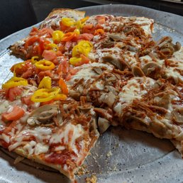 Half of the pizza had two kinds of peppers. The other half had sausage and mushrooms.