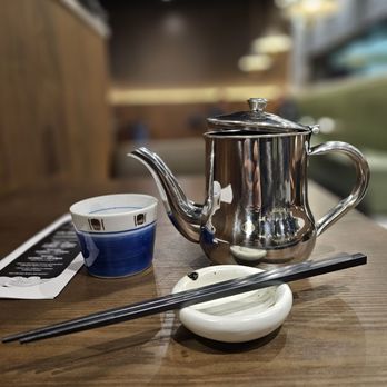 Kai Japanese Restaurant - a silver teapot and chopsticks on a wooden table - Japanese Near Me - Langley, British Columbia