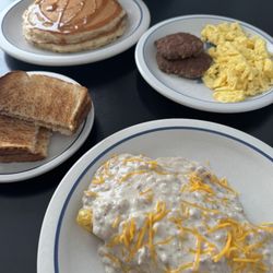 Dave's Omelette with Sausage gravy on top, sweet cream pancakes, scrambled eggs and sausage with toast