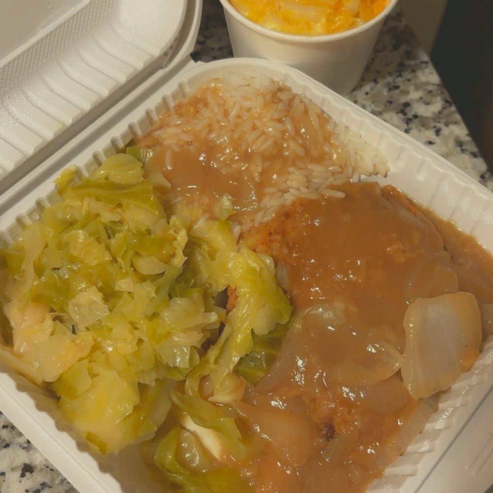 Smothered pork chops, cabbage and rice with mac and cheese