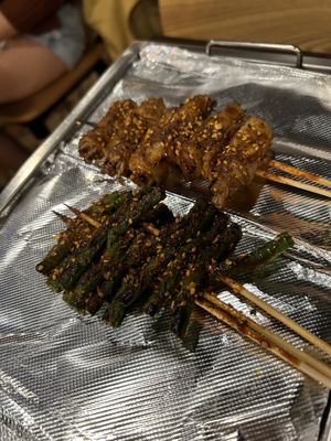 Photo of Friendship BBQ - Boston, MA, US. Green beans and pork belly wrapped enoki mushrooms skewers