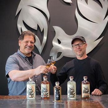 Slo De Vie - two men holding bottles of liquor - Distilleries Near Me - Grover Beach, California Slo De Vie - two men holding bottles of liquor - Distilleries Near Me - Grover Beach, California