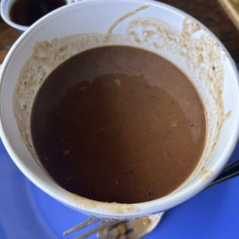 The Breakfast Klub - Bowl of liquid with a few beans at the bottom. - Breakfast & Brunch Near Me - Houston, Texas