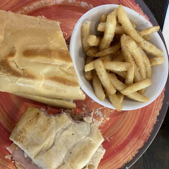 Mambos Cuban Cafe - Partially eaten Cuban Sandwich - Cuban Near Me - Jacksonville, Florida