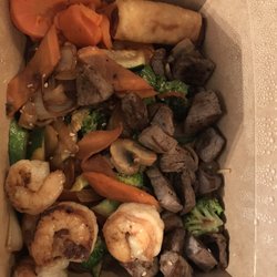 Filet Mignon Shrimp Combo. Sweet carrots vegetables spring roll over noodles.