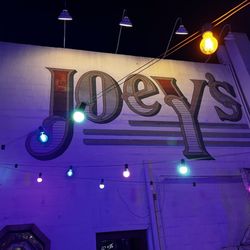 Joey's - Outside patio Sign painted on the wall of the restaurant!