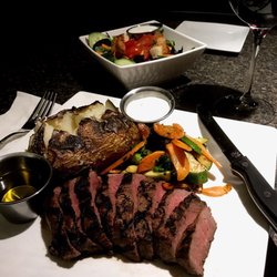 Sioux Valley Grille - Grilled flat iron steak plate with sautéed vegetable and a baked potato, served with drawn butter and sour cream.