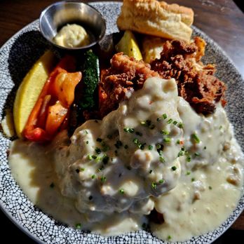 Reunion Kitchen + Drink - Rosemary's Chicken and Biscuit - Hand-battered & fried crisp | Yukon mashed potatoes & sausage gravy | roasted vegetables - New American Near Me - Brea, California Reunion Kitchen + Drink - Rosemary's Chicken and Biscuit - Hand-battered & fried crisp | Yukon mashed potatoes & sausage gravy | roasted vegetables - New American Near Me - Brea, California
