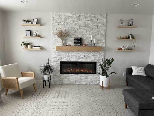 Fireplace installation - A cozy fireplace just in time for the winter days is the perfect addition to any room of your house. This is an addition to an older home without a fireplace. Look how well it brings the room together. The electric fireplace is the alternative to CA laws about forbidding wood burning ones. The mantle is custom made from pure oak. The stacked stone can create a high-value look in any living space. Our tile experts can bring your vision to real life right there in your home. Fireplace installation - A cozy fireplace just in time for the winter days is the perfect addition to any room of your house. This is an addition to an older home without a fireplace. Look how well it brings the room together. The electric fireplace is the alternative to CA laws about forbidding wood burning ones. The mantle is custom made from pure oak. The stacked stone can create a high-value look in any living space. Our tile experts can bring your vision to real life right there in your home.