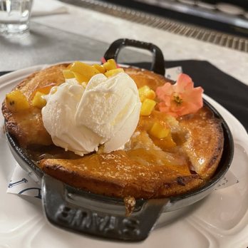 Justine - Peach cobbler. Not too sweet. Tastes like pound cake. Tasty - French Near Me - New Orleans, Louisiana Justine - Peach cobbler. Not too sweet. Tastes like pound cake. Tasty - French Near Me - New Orleans, Louisiana