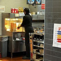 McDonald's - Miss Thang has her weave draping all over the food station.