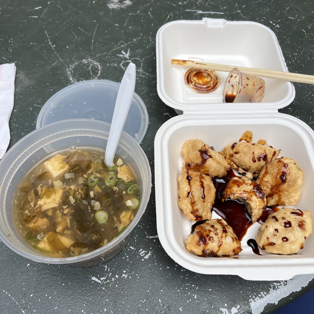 two takeout containers of food