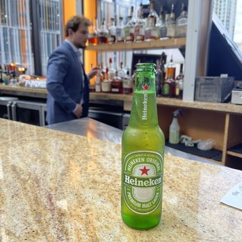 The Bridge - a bottle of heineken beer sitting on a bar - New American Near Me - Nashville, Tennessee The Bridge - a bottle of heineken beer sitting on a bar - New American Near Me - Nashville, Tennessee