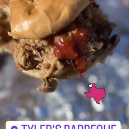 Pulled Pork Sandwich - Close-up of a pulled pork sandwich with barbecue sauce from Tyler's Barbeque in Amarillo, Texas, with a location tag and Texas map icon.