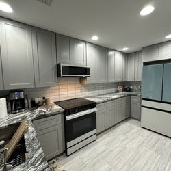 JP Home Carpentry - After, new cabinets and new appliances, larger refrigerator. Same floor and granite countertop.