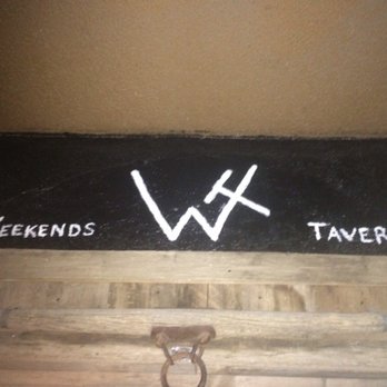Weekends Tavern - a wooden bench with a sign on it - Bars Near Me - Alamosa, Colorado