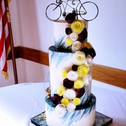 Pixie Cake Art - Tall and hand painted blue wedding cake with a hidden Harry Potter surprise.... a snitch crashed into the side of the cake!