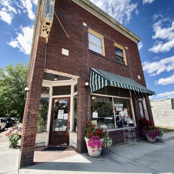 Corner Door - a brick building with a green and white awning - Bookstores Near Me - Spokane, Washington